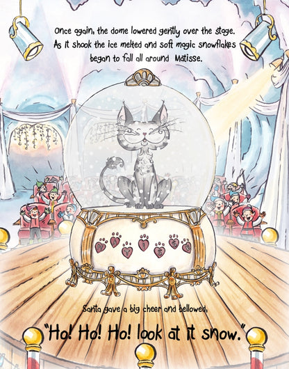 Matisse the Cat making snow in the globe. From Matisse and Santa’s Magic Snow Globe. A children's picture book from 'The Curious Adventures of Matisse the Cat' series.