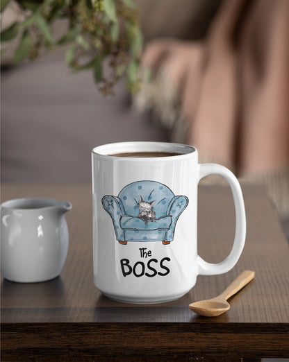 USA Matisse the cat the boss 15oz jumbo mug displayed on an occasional table beside a wooden spoon and small milk jug.