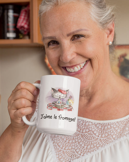 Matisse the Cat 15oz jumbo mug. With the slogan J'aime le fromge. Being held by a mature lady smiling in her kitchen.