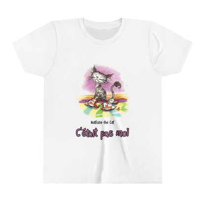 A white official, Matisse the Cat children’s t-shirt with the slogan “c'était pas moi” (It wasn’t me) featuring Matisse sitting on a vibrant carpet, his innocent gaze fixed upon a broken vase.