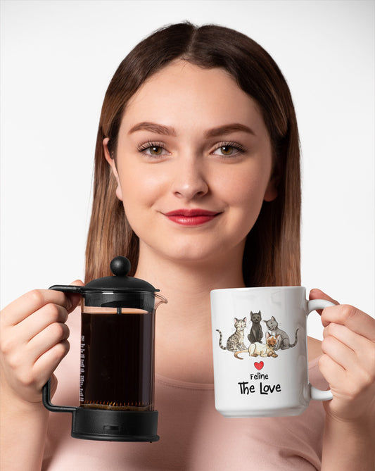 Matisse the cat Feline the Love 15oz jumbo mug held by a young woman.