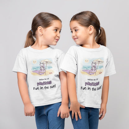 A white official, Matisse the Cat children’s t-shirt with the slogan ‘Pawsome Fun in the Sun ‘ showcases Matisse at the beach, relaxing on a sun lounger sipping a mile shake. Worn by twin girls, standing side by side looking at each other.