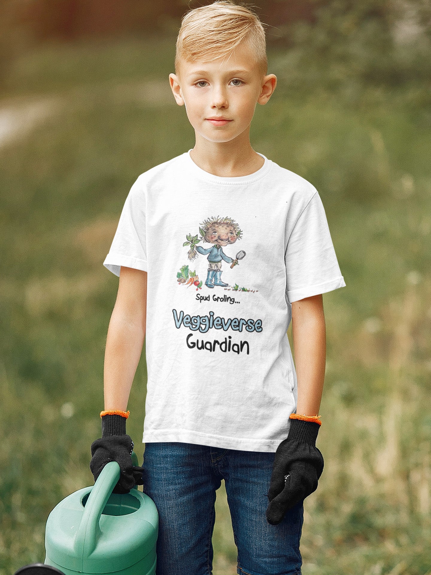 A white official USA Grolings kids t-shirt featuring the phrase 'Spud Groling... Veggieverse Guardian. The t-shirt showcases Spud Groling, standing with a freshly harvested potato plant in his hand, surrounded by a variety of fresh vegetables. Spud Groling's message encourages the wearer to embrace a role as a protector and caretaker of the vegetable world. Worn by a young boy holding a watering can.