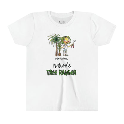 A white official USA Grolings kids' t-shirt, featuring the phrase 'Palm Groling... Nature’s Tree Ranger.' The t-shirt showcases Palm Groling, holding a young tree in one hand and pruning shears in the other. In the background, a majestic palm tree stands tall. The scene emphasises the importance and grandeur of trees as essential components of the Earth's ecosystem, promoting a sense of awe and reverence for these green giants. 